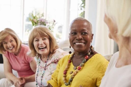Group of senior female friends laughing.