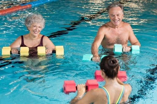 A senior couple does a water workout.